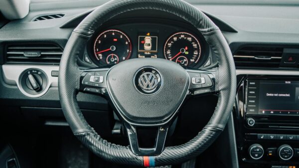 Detailed view of Volkswagen car interior showing steering wheel and dashboard.