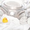a rubber ducky toy sitting inside of a washing machine