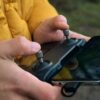 Close-up of a person's hands operating a drone controller outdoors in İstanbul.