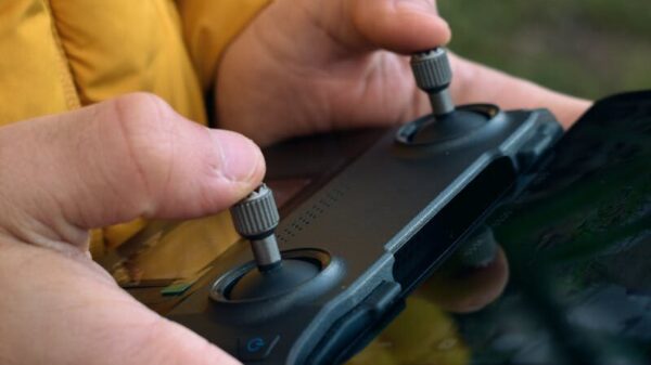 Close-up of a person's hands operating a drone controller outdoors in İstanbul.