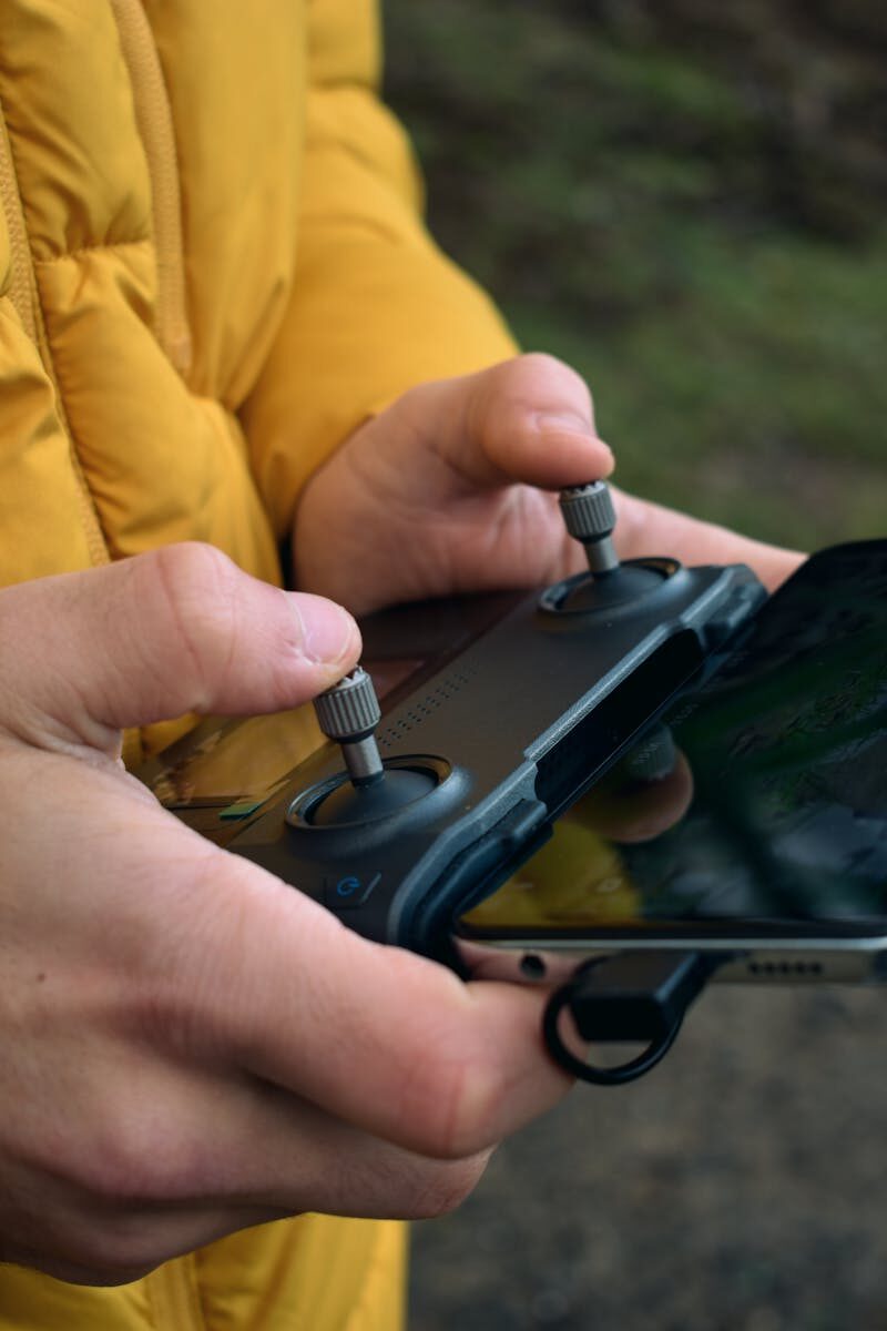 Close-up of a person's hands operating a drone controller outdoors in İstanbul.