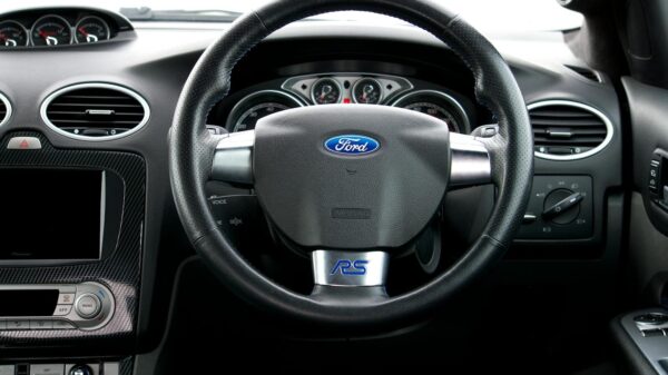 Interior view of a Ford Focus RS, showcasing the steering wheel and dashboard details.
