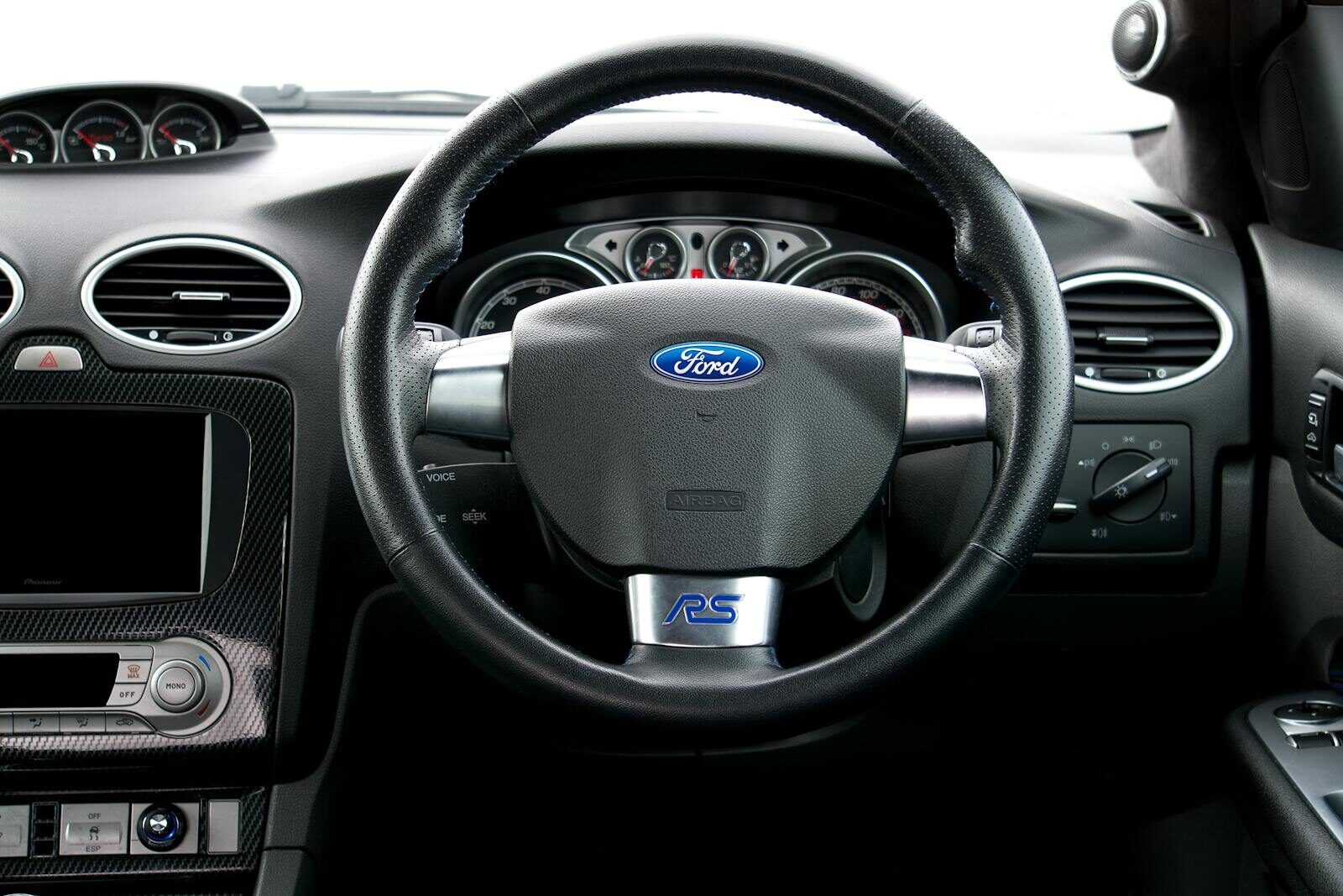 Interior view of a Ford Focus RS, showcasing the steering wheel and dashboard details.