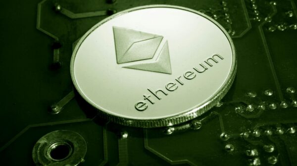 Close-up of an Ethereum coin placed on a circuit board, symbolizing digital currency technology.