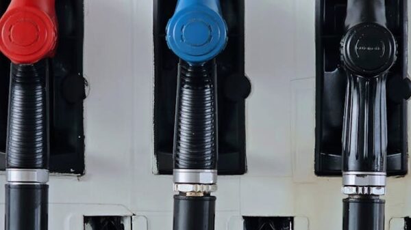 Close-up of multicolored fuel pumps at a gas station, showcasing different types of fuel.