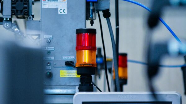 Detailed view of automated machinery with warning signals in an industrial setting.