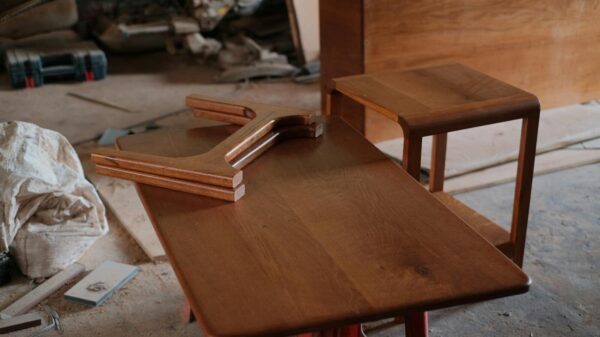 Wooden furniture pieces on a workshop table, demonstrating craftsmanship.