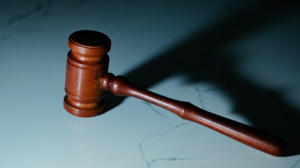a wooden judge's hammer sitting on top of a table