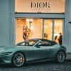 A sleek Ferrari parked in front of a Dior store in Istanbul, capturing a blend of luxury and elegance.