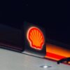 Illuminated Shell gas station sign captured at night in Bengaluru, India.