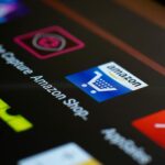 Close-up of the Amazon shopping app icon on a smartphone screen. Ideal for online shopping and technology themes.