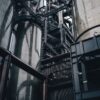 Low angle view of towering industrial silos in Luxembourg, showcasing modern production infrastructure.