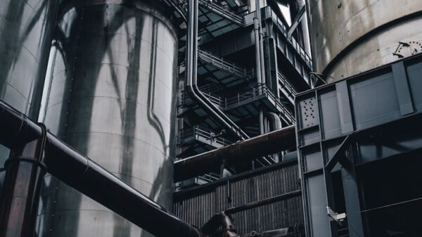 Low angle view of towering industrial silos in Luxembourg, showcasing modern production infrastructure.