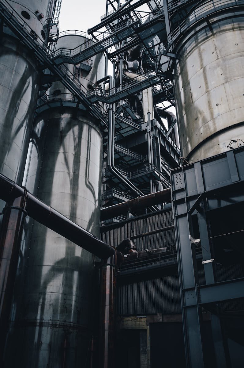 Low angle view of towering industrial silos in Luxembourg, showcasing modern production infrastructure.
