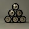 Metallic AA batteries stacked in a pyramid shape, symbolizing power and energy storage.