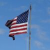 US flag flying in clear blue sky at Mackinac Island, MI. Symbol of American patriotism.