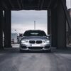 Front view of a silver BMW in a modern urban environment, Antwerp.