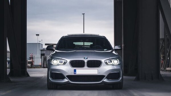 Front view of a silver BMW in a modern urban environment, Antwerp.