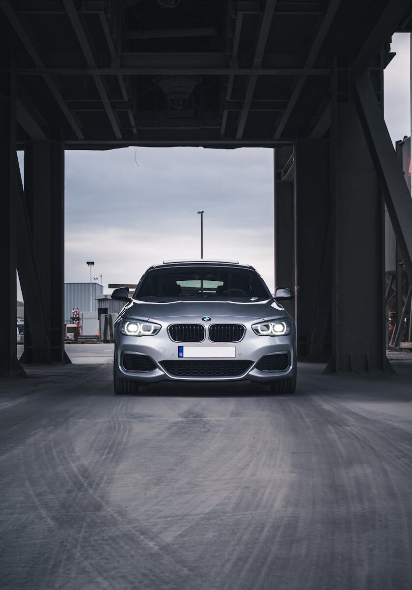 Front view of a silver BMW in a modern urban environment, Antwerp.