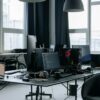 Contemporary workspace featuring computers, coding screens, and office essentials in a tech environment.