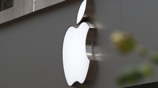 Close-up of Apple Store exterior featuring the illuminated logo prominently displayed.