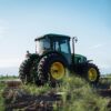 A vibrant green tractor on a farm in Mendoza, Argentina, under clear blue skies.
