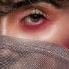 woman covering her face with gray textile