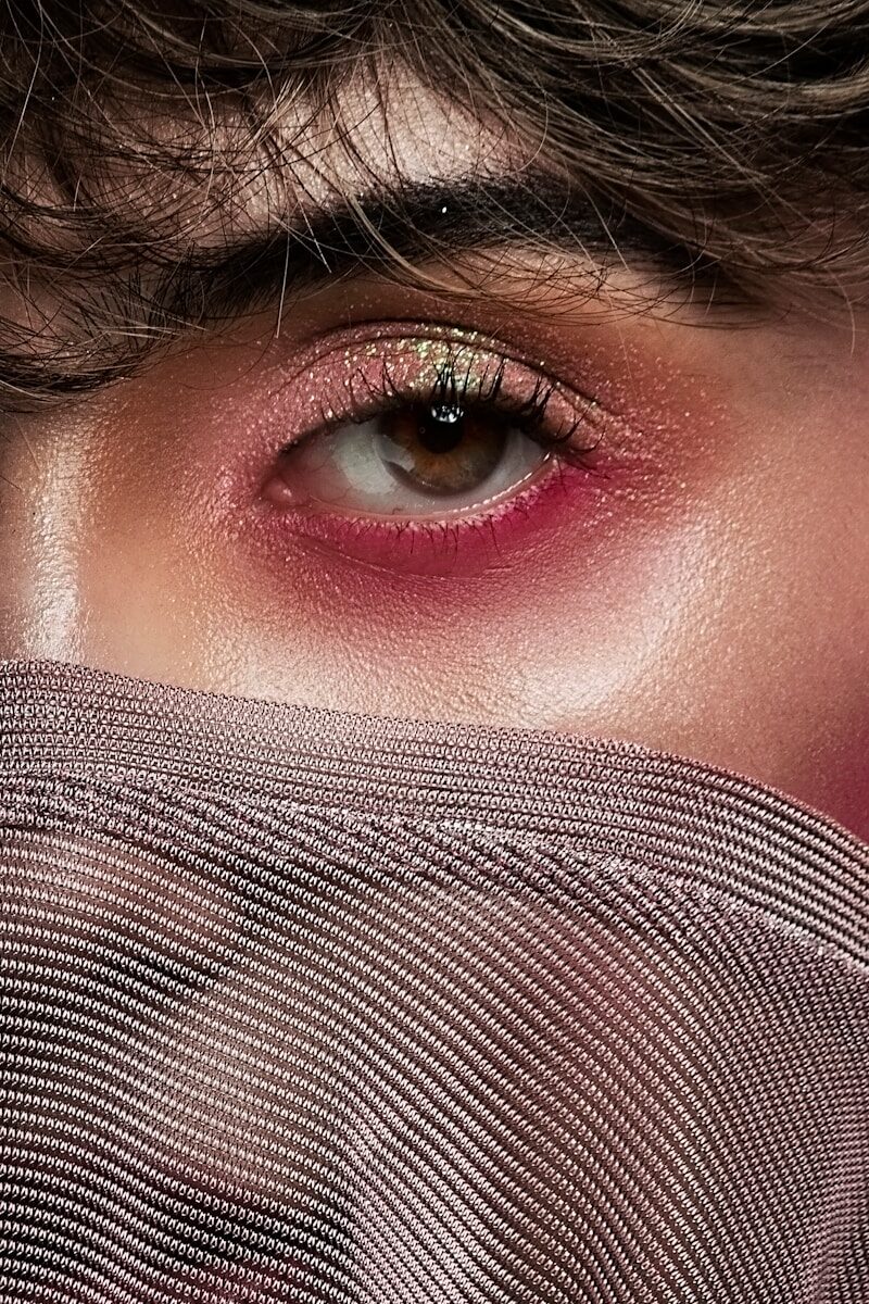 woman covering her face with gray textile