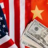 From above of United States banknotes placed on national flags of America and China illustrating international trade concept