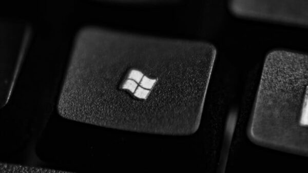 High-quality close-up of a Windows logo key on a black plastic keyboard.