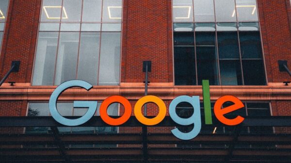 Colorful Google logo on modern building exterior in urban environment.