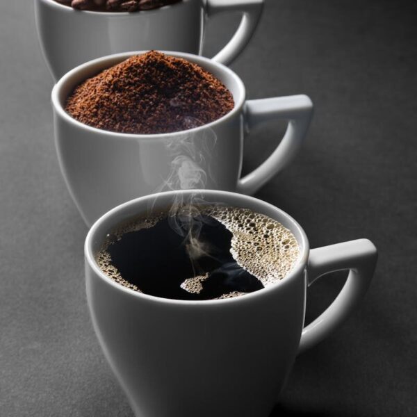 A journey of coffee from beans to a fresh brew in three cups, highlighting the stages of preparation.