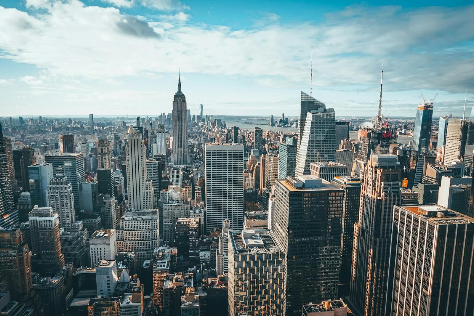 Stunning aerial view of New York City skyline featuring the iconic Empire State Building and skyscrapers.