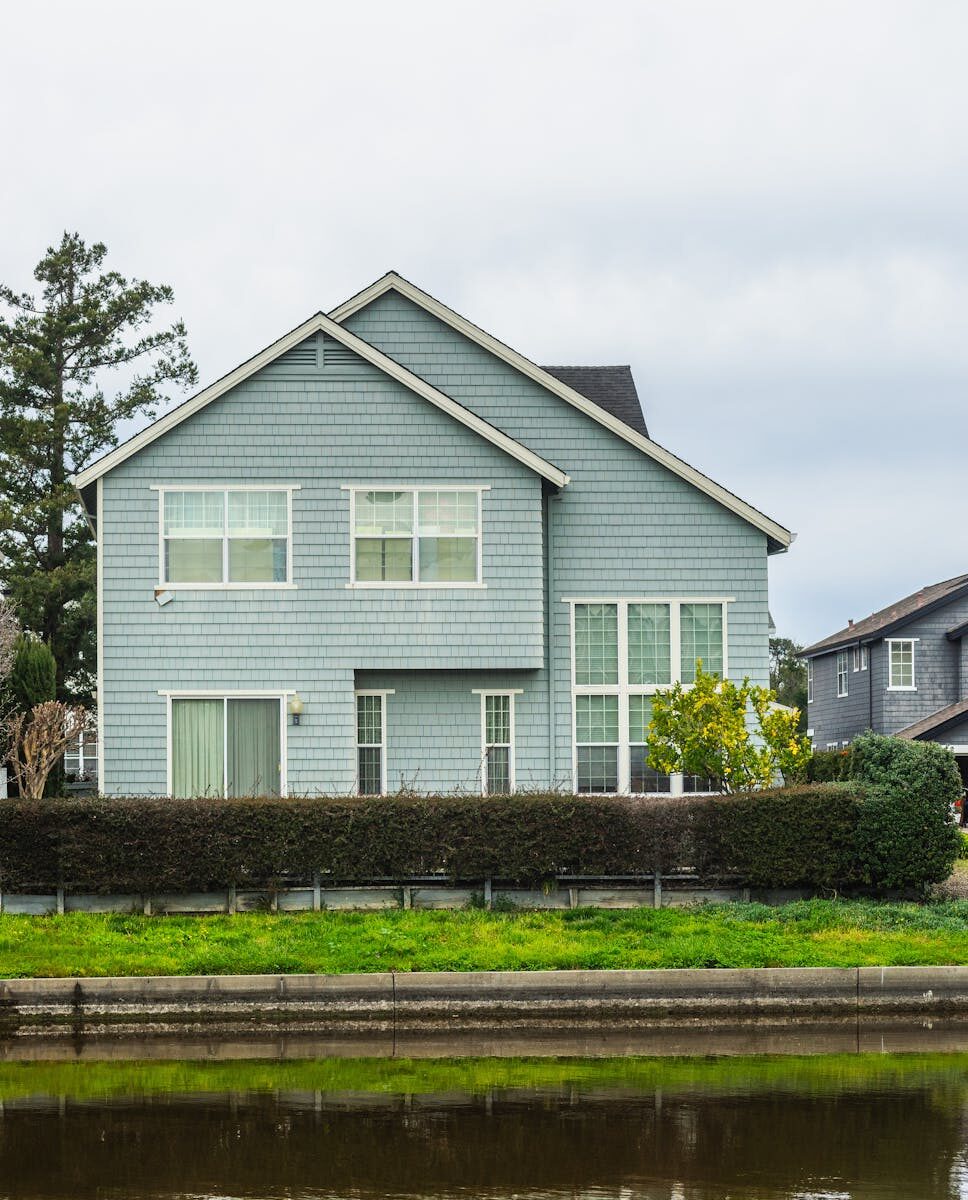 A contemporary detached house in a suburban neighborhood with a scenic canal front.