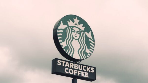 A Starbucks Coffee sign with a cloudy sky backdrop in Brazil, creating a moody ambiance.
