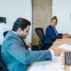 Diverse professionals collaborating in modern office setting, fostering teamwork.