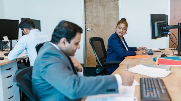 Diverse professionals collaborating in modern office setting, fostering teamwork.