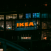 Illuminated view of an IKEA store in Bangkok at night, showcasing vibrant city lights.