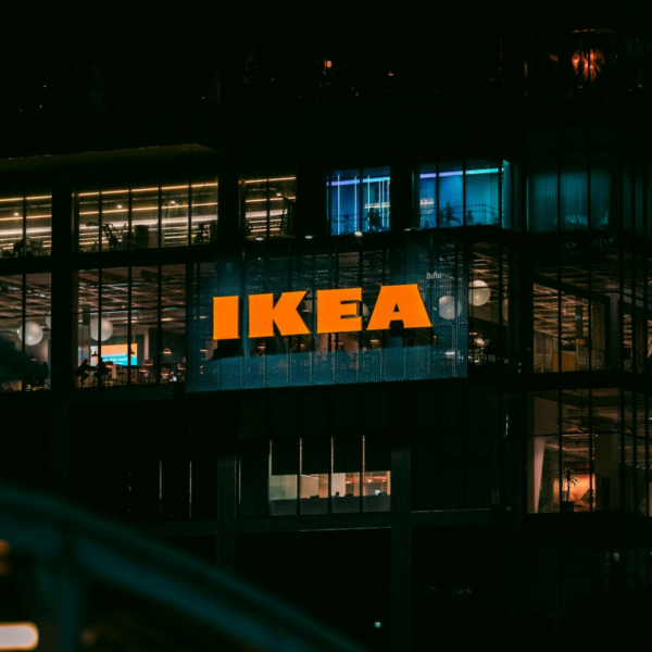 Illuminated view of an IKEA store in Bangkok at night, showcasing vibrant city lights.
