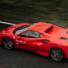 Dynamic shot of a red supercar speeding on a race track in Pau, France.