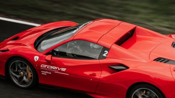 Dynamic shot of a red supercar speeding on a race track in Pau, France.