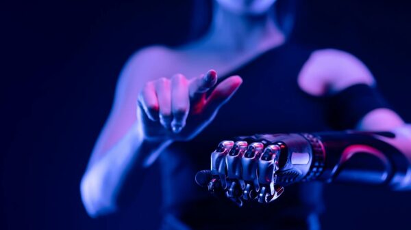 Close-up of a robotic hand with a woman pointing, showcasing advanced prosthetic technology.