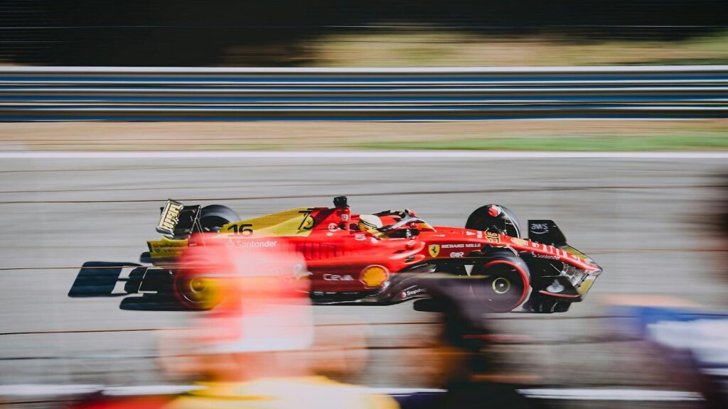 A thrilling shot of a Ferrari on the race track during the Italian Grand Prix.