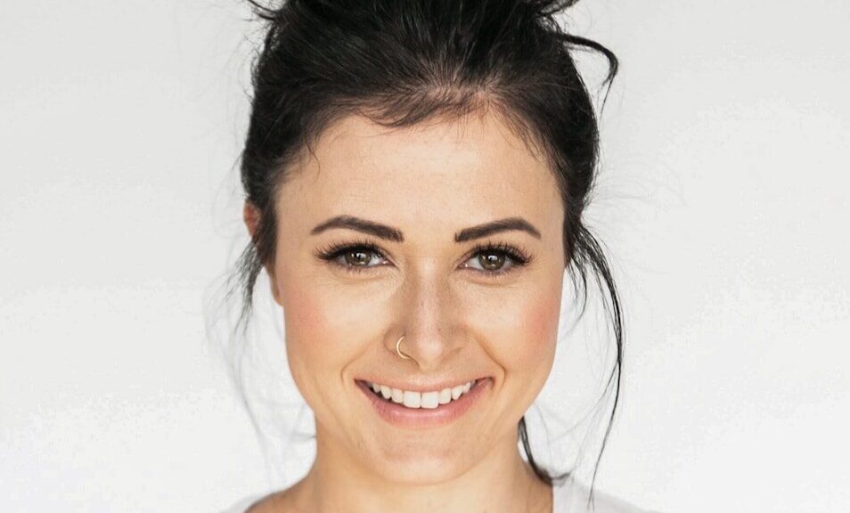 woman in white crew neck shirt smiling