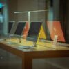 Vibrant desktop computers showcased on a wooden table in modern retail environment.
