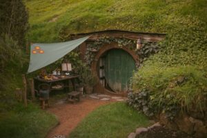 A charming hobbit-inspired house nestled in lush greenery, capturing the essence of rustic countryside living.