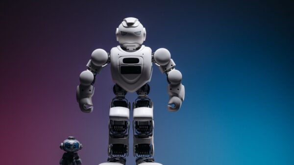 Close-up shot of two white robots displayed on a colorful gradient background symbolizing innovation in robotics.