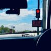 Car interior view at a toll booth in Suryapet, India with a stoplight.