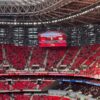 A bustling stadium during the FIFA World Cup CAF Qualifiers, showcasing vibrant crowds and electric atmosphere.