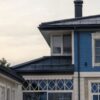 A stylish blue house featuring unique geometric windows, showcasing modern architecture.